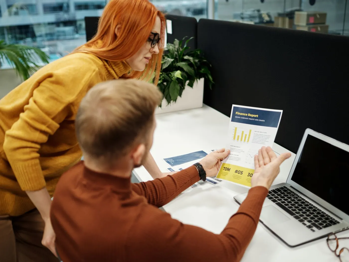 A consultant and a nonprofit leader calmly reviewing a checklist together at a desk
